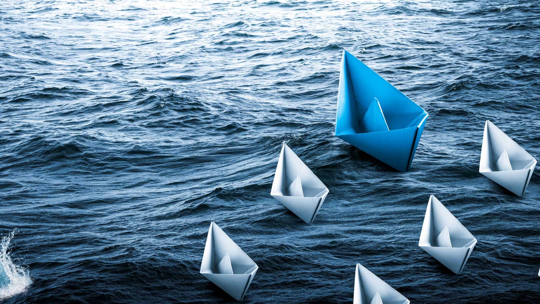 Paper boats on the water, leadership theme